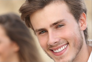 Smiling man in casual setting with blurred background at Falls Pointe community.
