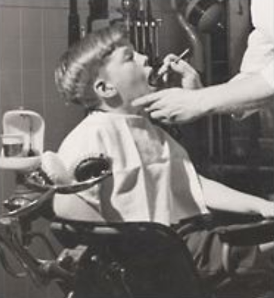 Child receiving dental treatment in vintage black and white photograph at Falls Pointe.