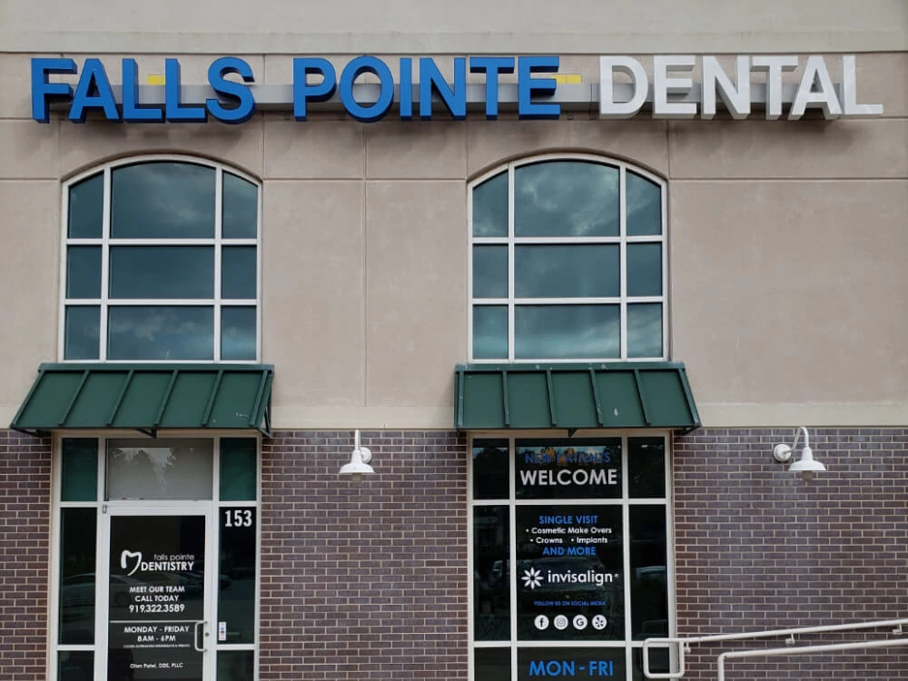 Falls Pointe Dental storefront with brick facade, large windows, and welcoming entrance signage.