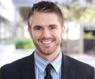Professional headshot of smiling man in business attire outdoors at Falls Pointe location.