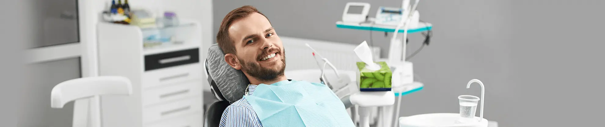 Man in dental chair during examination at modern dental office