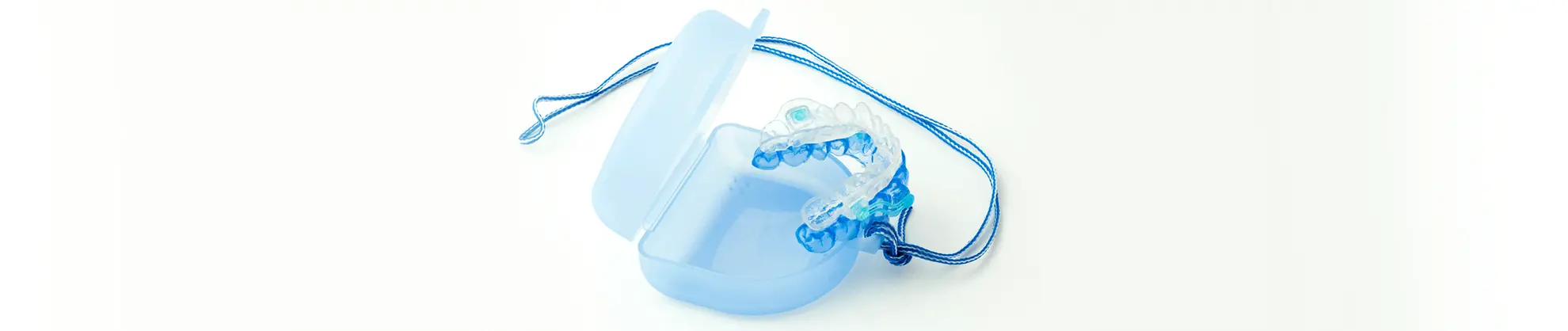 Blue mouthguards against light background