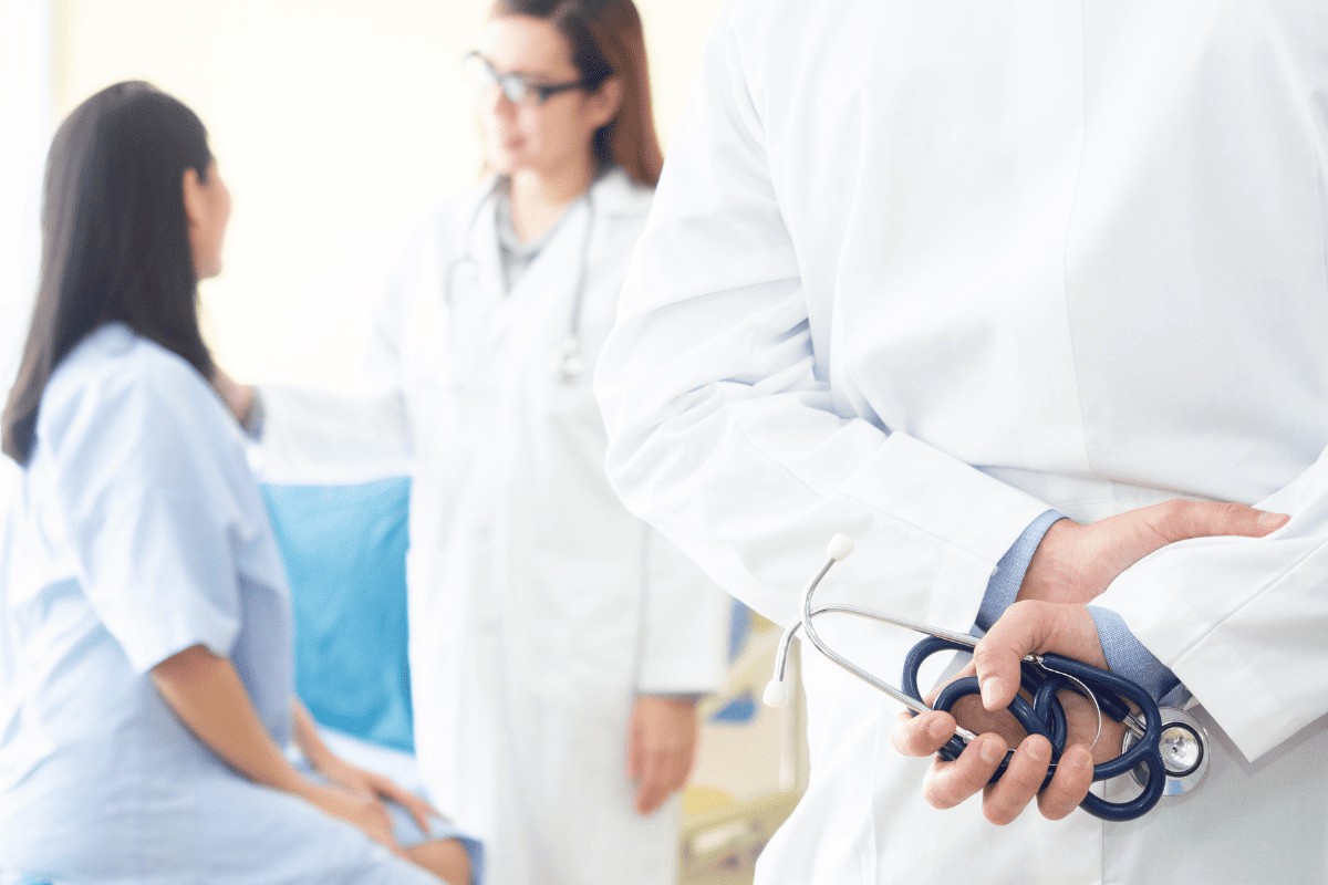 Dentist holding a stethoscope near a patient