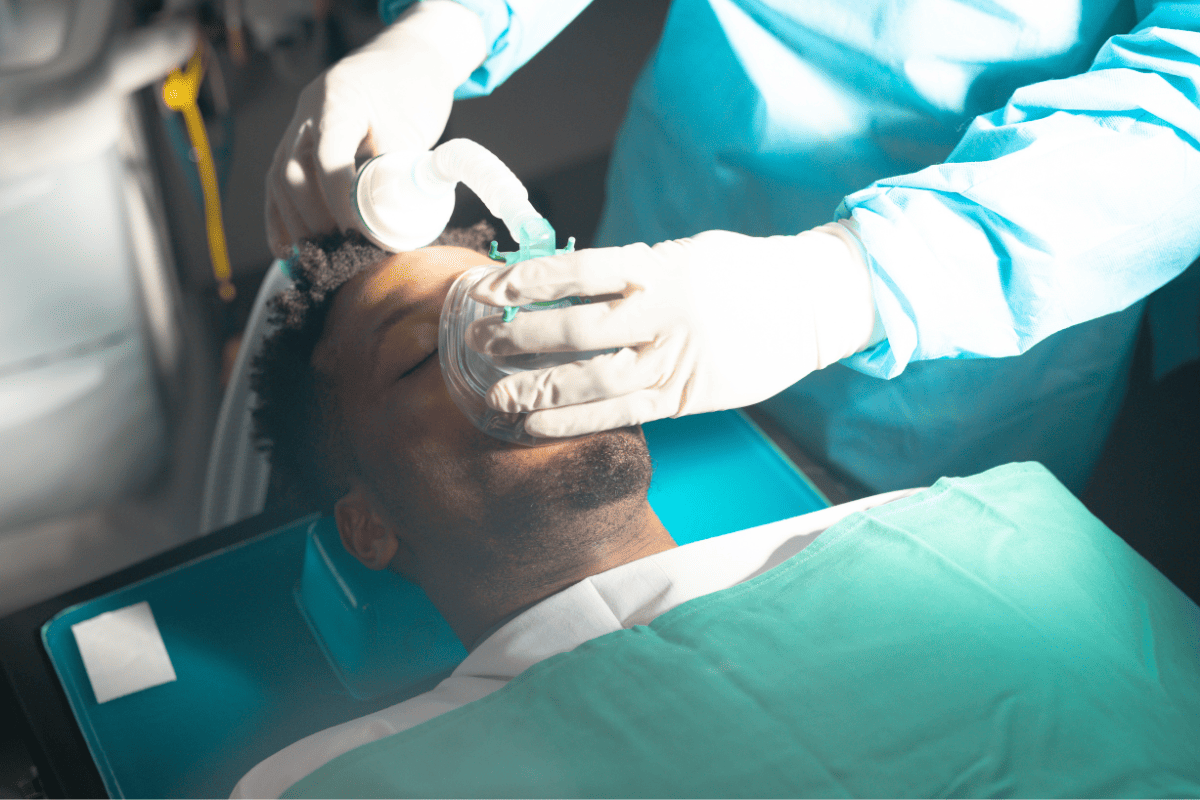 Patient receiving sedation from dentist