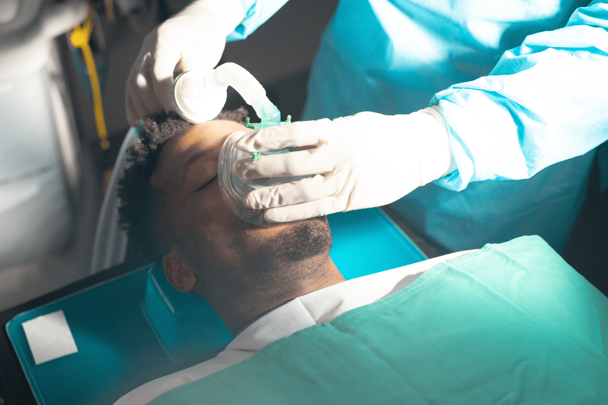 Patient receiving sedation from dentist